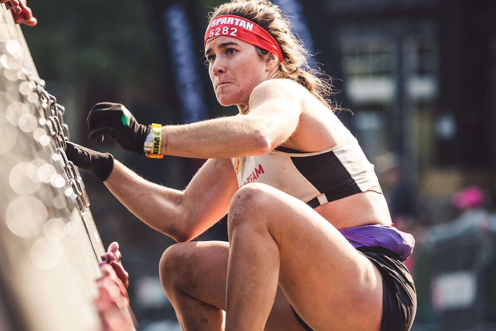 A Spartan race athlete climbing an obstacle course.