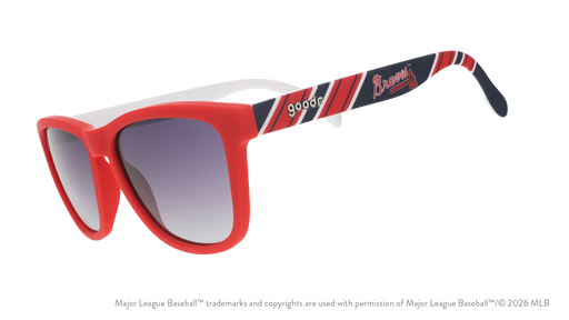 Three-quarter angle view of red, white, and navy Braves sunglasses featuring the script and tomahawk logo on the arm.