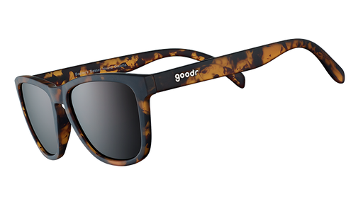 Three-quarter angle view of square brown tortoiseshell sunglasses with brown non-reflective lenses on a white background. 