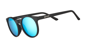 Three-quarter angle view of retro-inspired black round sunglasses with circle-shaped mirrored blue lenses.