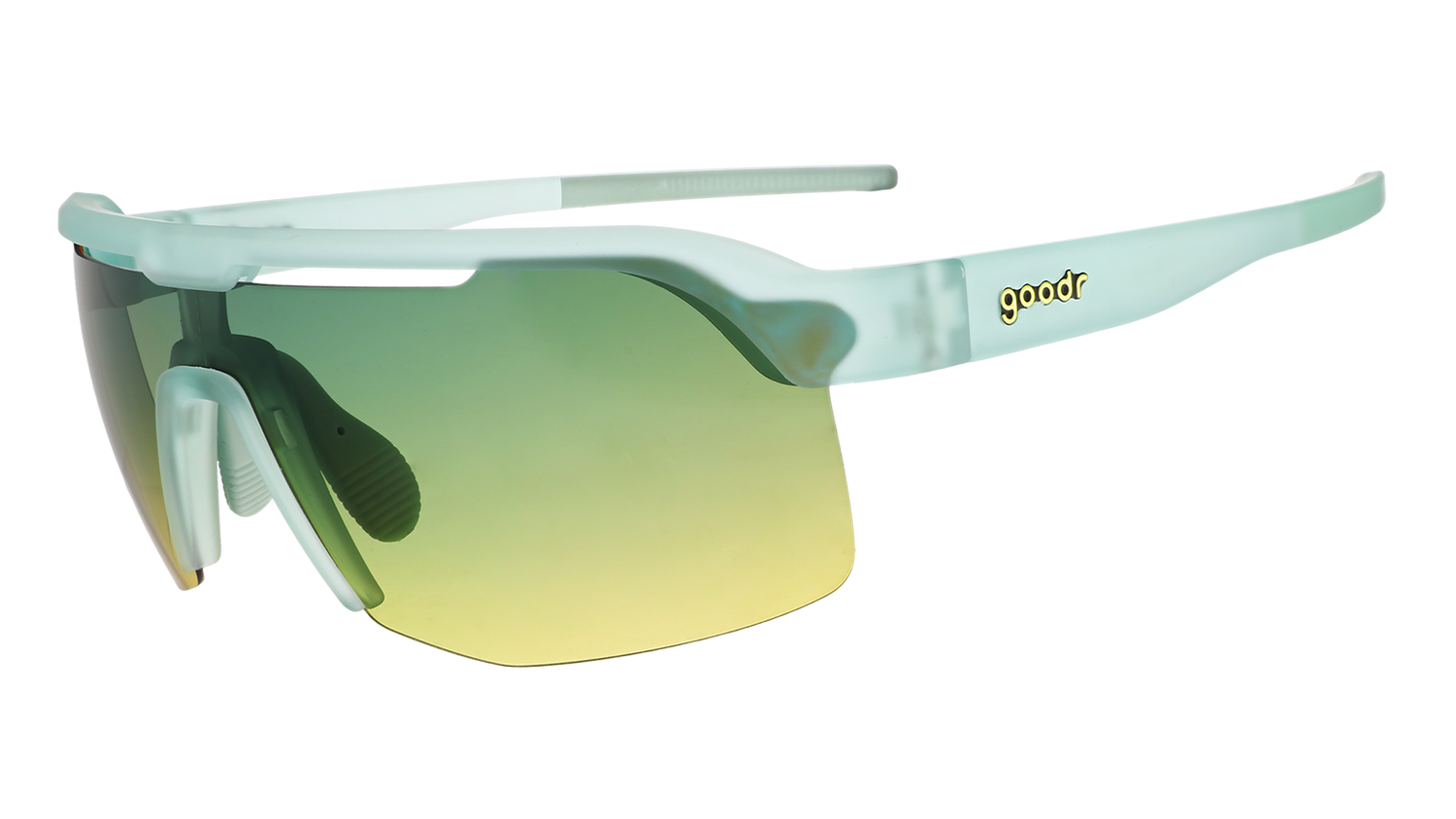 A pair of sport sunglasses with a translucent mint green frame and a green-to-yellow gradient lens, shown on a plain white background. The brand name 'goodr' is visible on the temple.