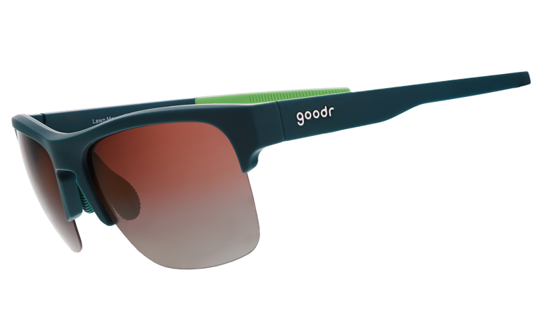 Three-quarter angle view of solid green half-rim sunglasses featuring polarized rose gradient lenses and lime green silicone grips on the inner right arm.