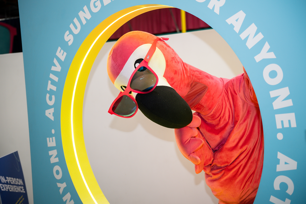 Flamingo wearing sunglasses with a blue background