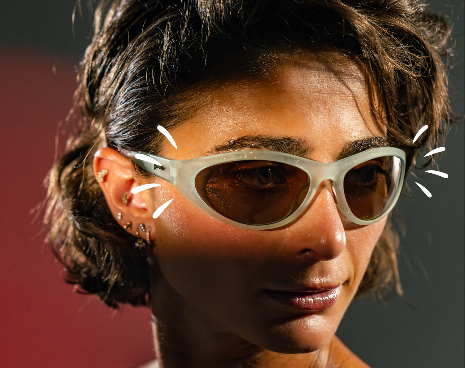 Close-up of Alexi Papas wearing sunglasses with a blurred background