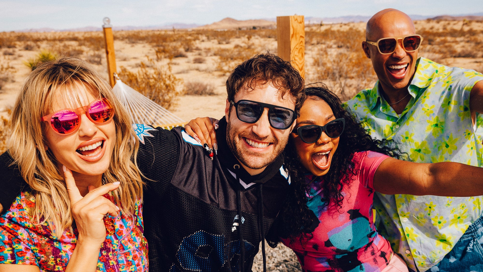 Friends smiling outdoors wearing goodr sunglasses.