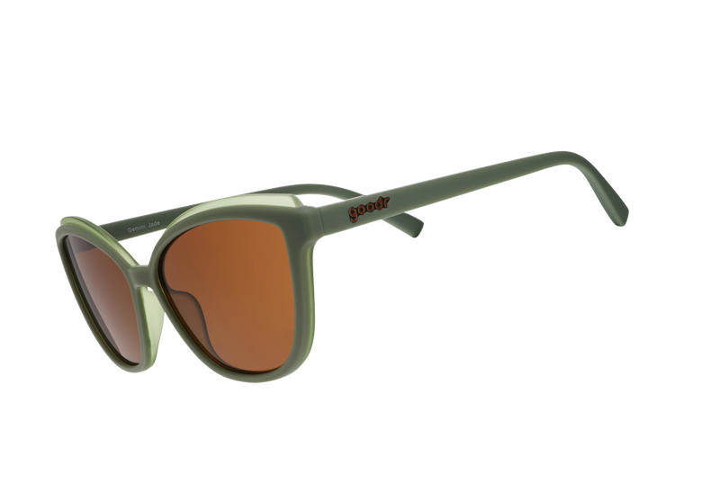 Green sunglasses with brown lenses on a white background