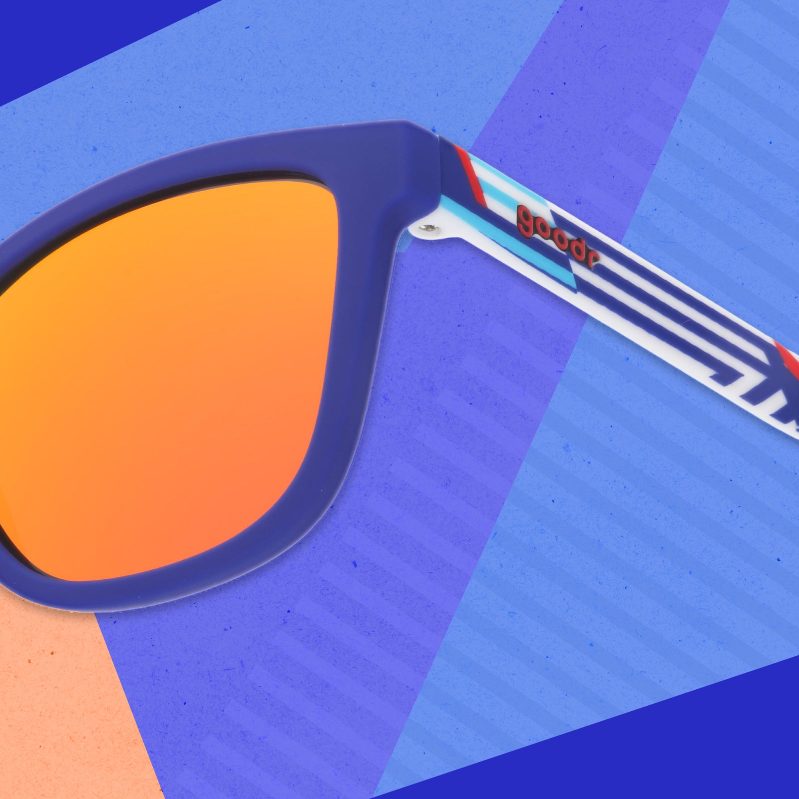Close-up view of the temple on a pair of blue sunglasses with a geometric nautical-inspired design on the arms.