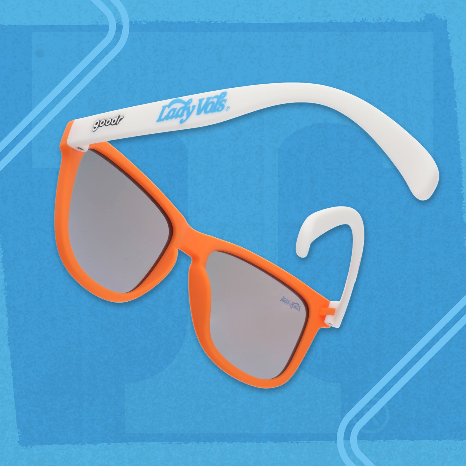Angled view of Lady Vols goodr sunglasses with an orange frame, white arms, and blue reflective lenses.