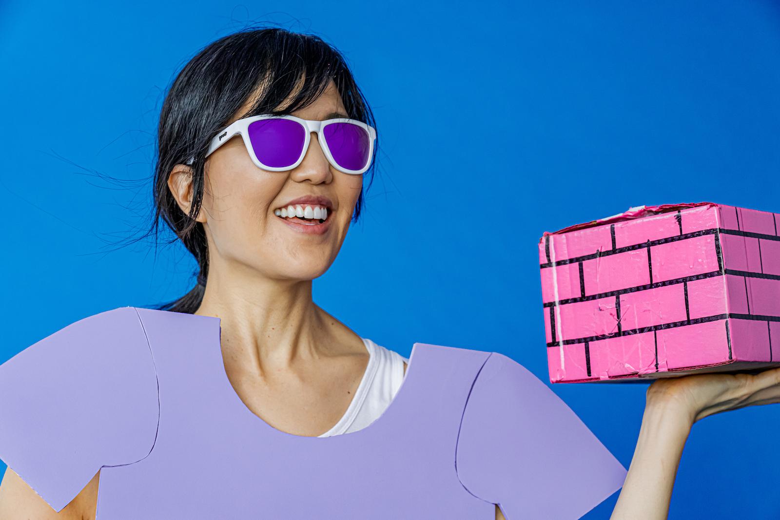 woman wearing white frame sunglasses with purple polarized lenses
